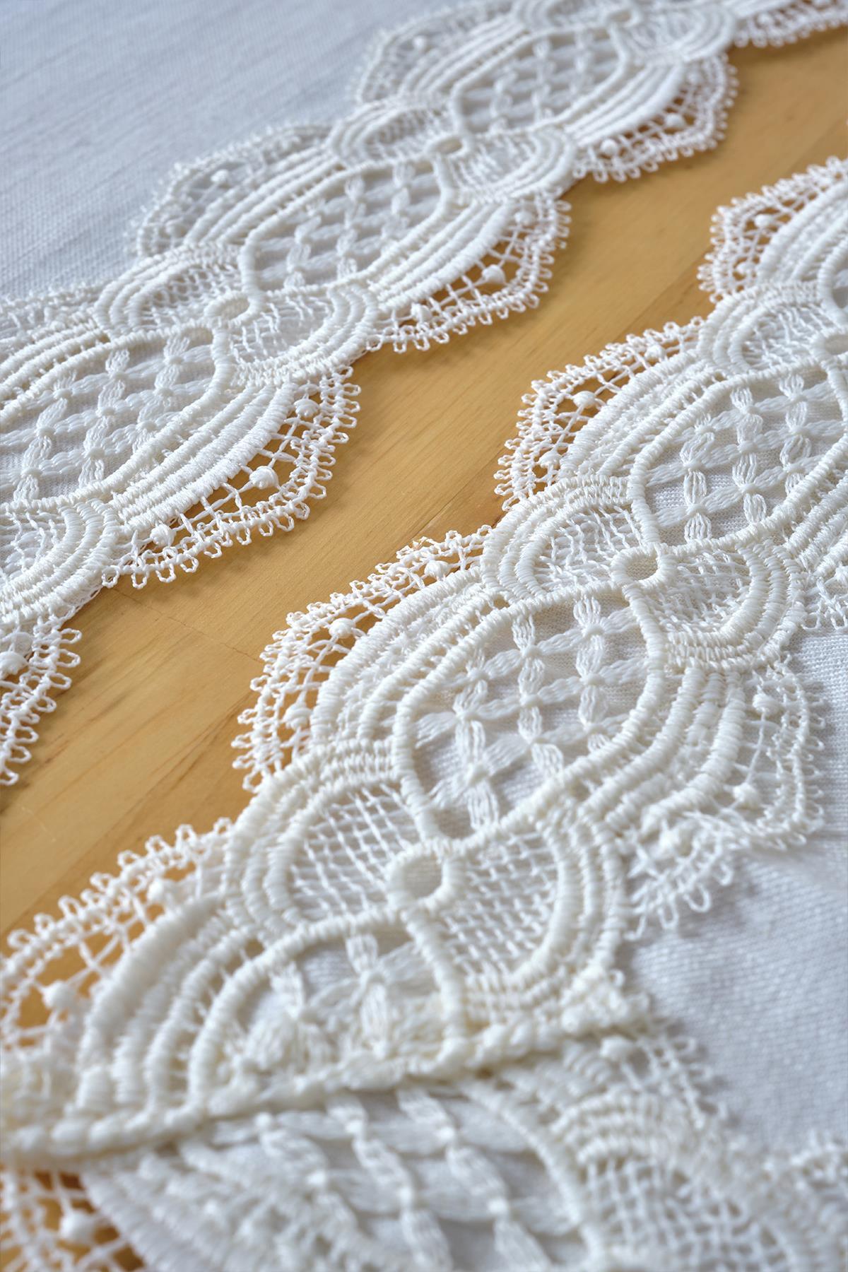White placemat with lace details laid on a tablecloth