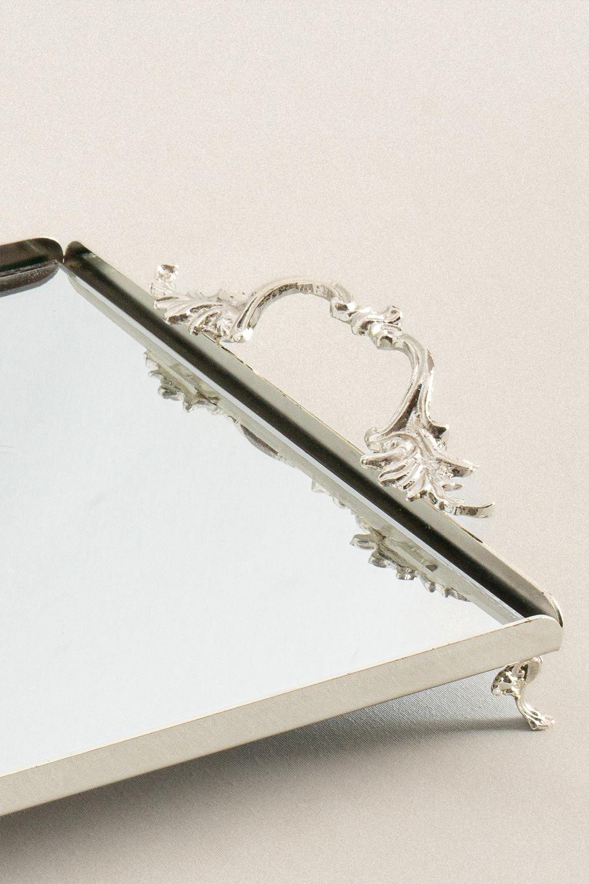 Large silver-colored serving tray with elegant handles, featuring intricate metalwork and a mirrored base design