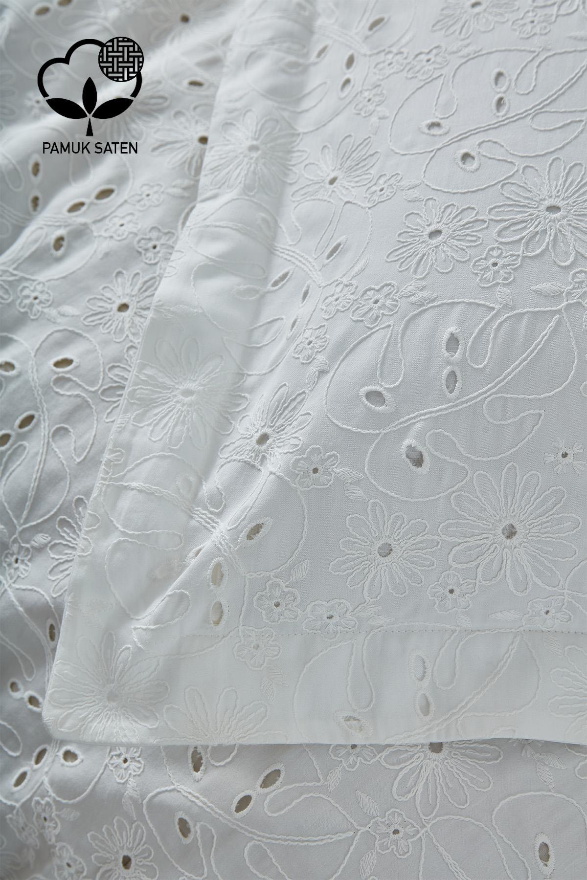 White cotton sateen duvet cover set with floral embroidery, detailed view of the double bedspread