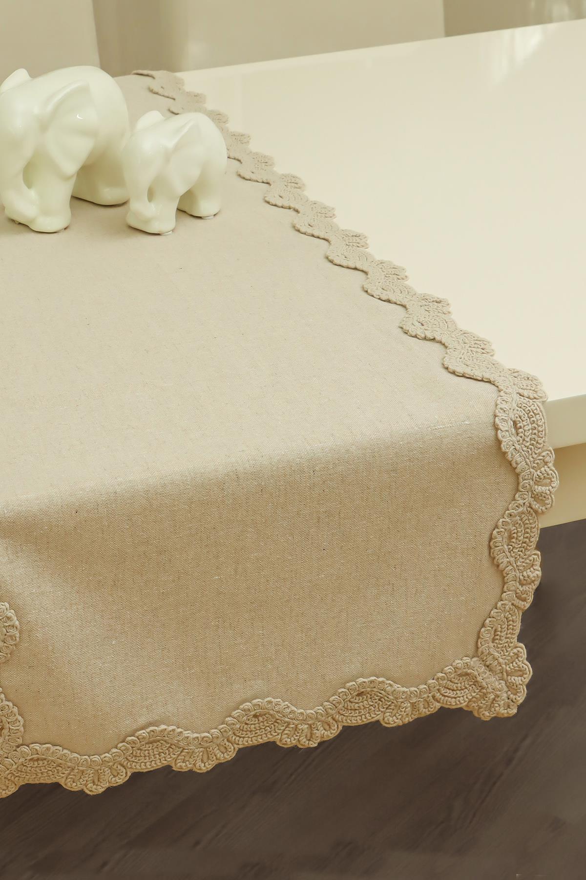 Beige table runner with lace detail, ceramic elephant decoration on top, stylish table decor