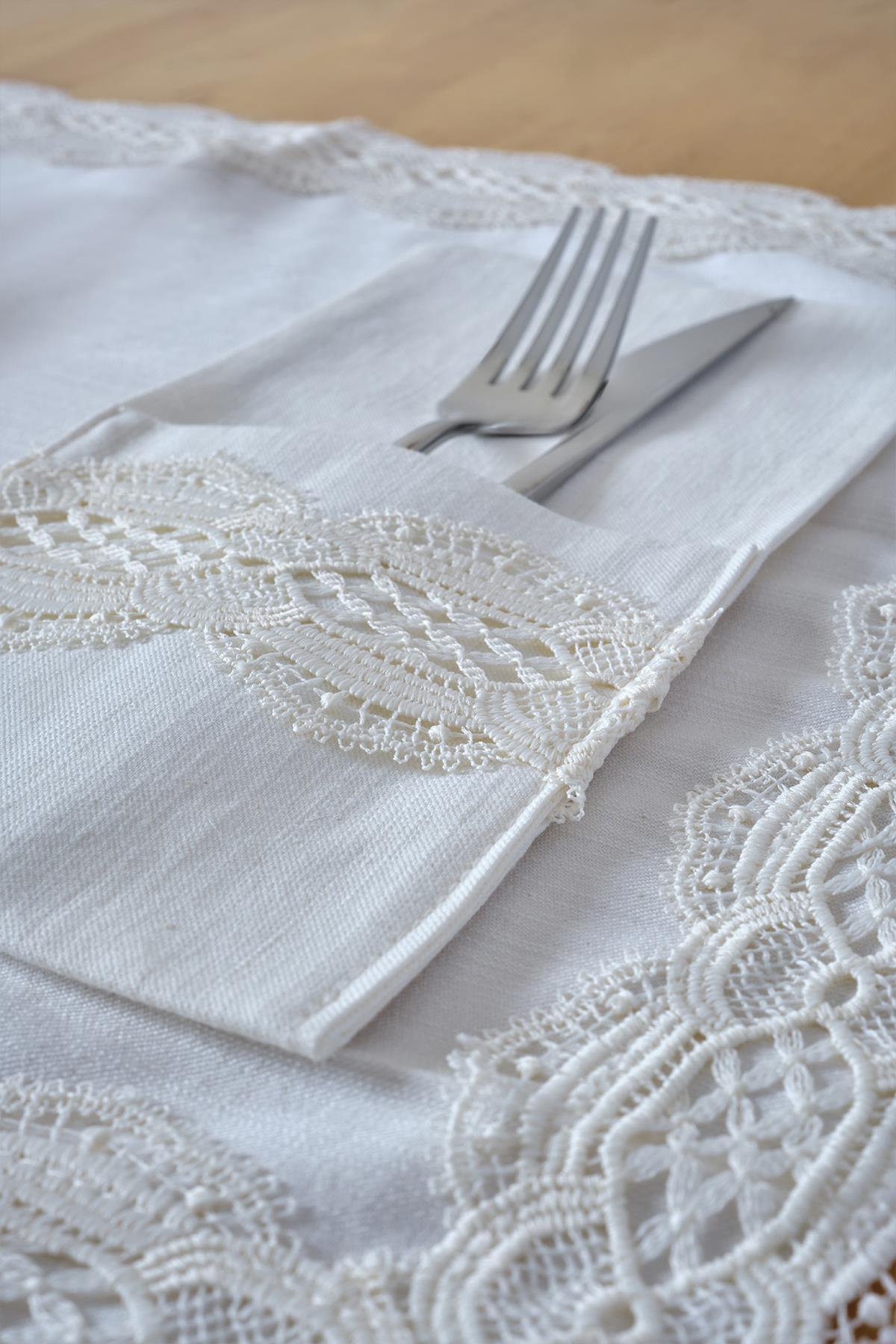 Fork and knife set on a white fabric napkin with lace detail