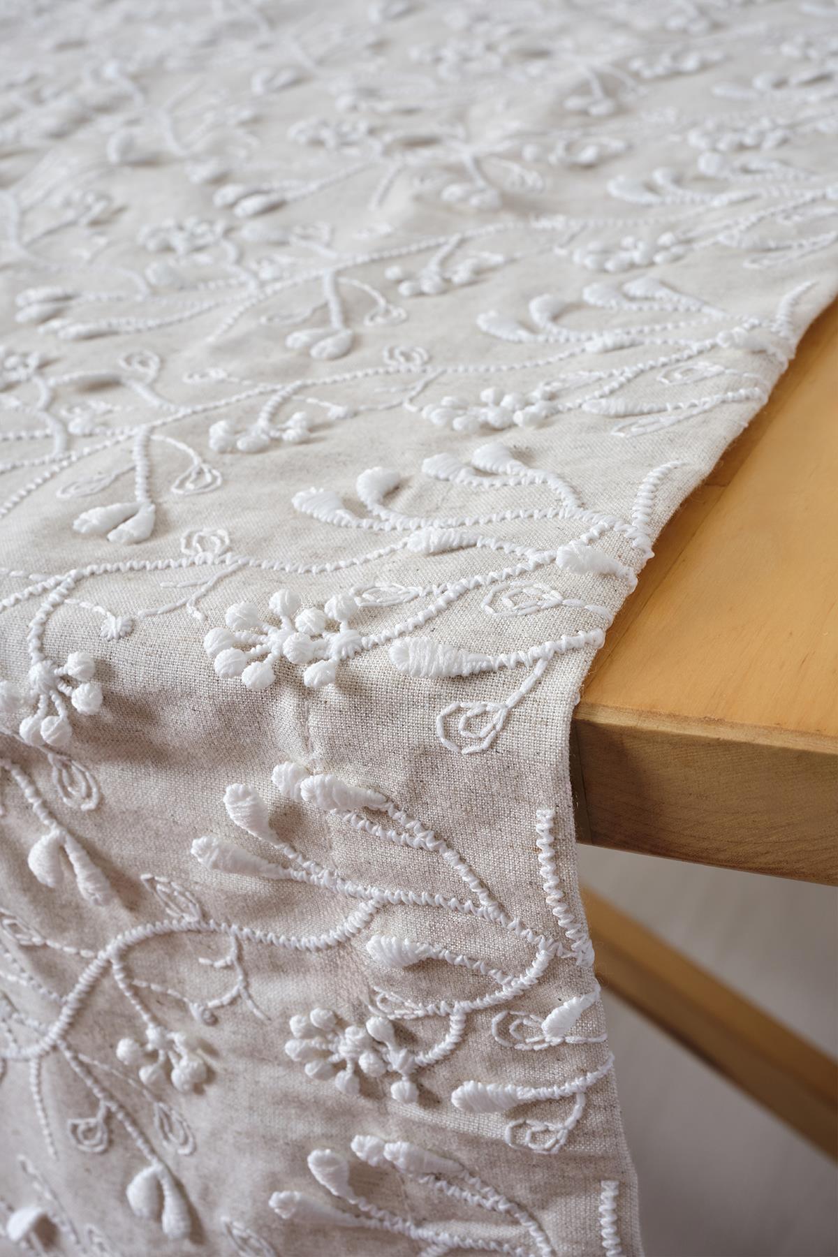 Stylish beige table runner with white embroidery, modern floral decor