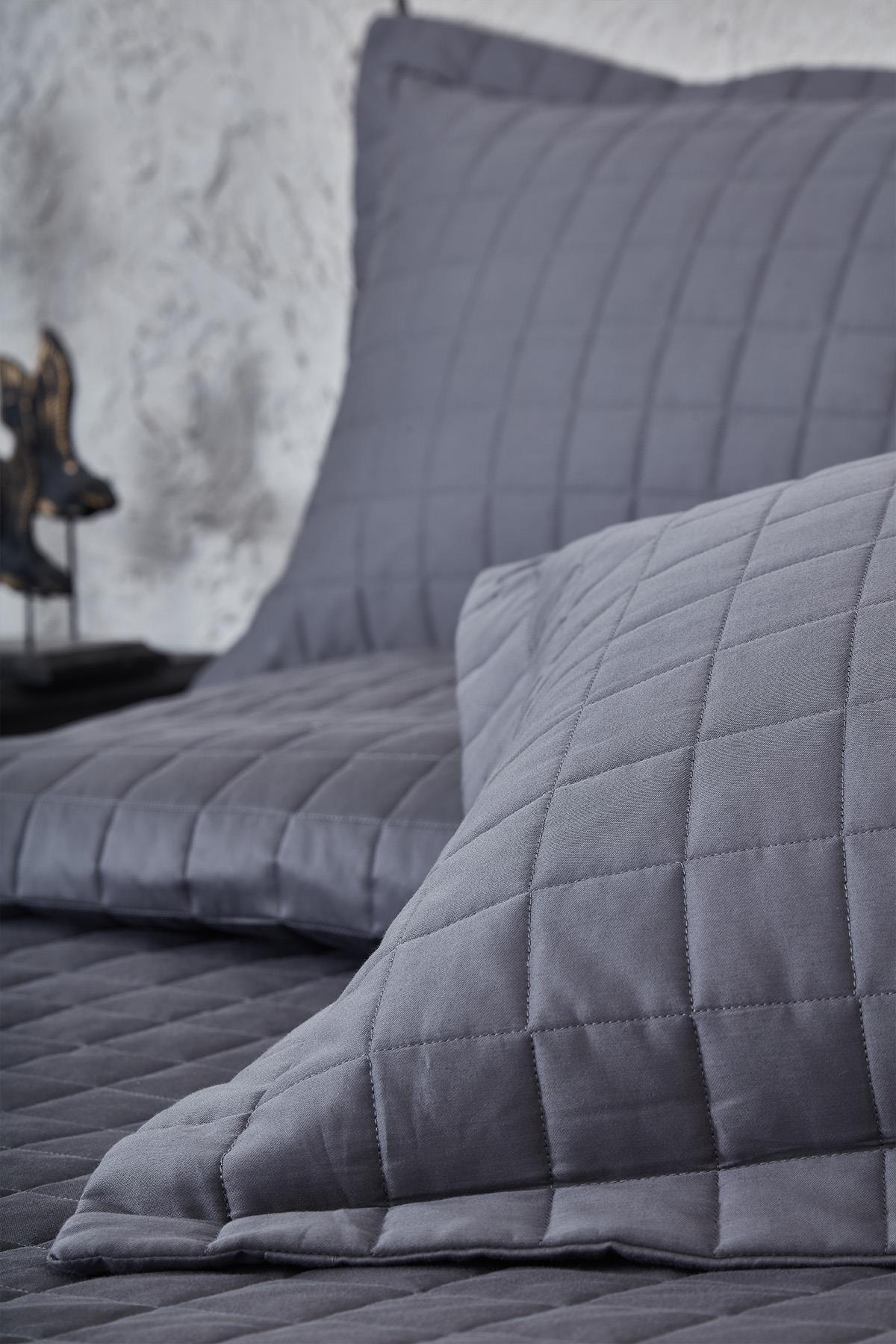 Gray quilted double bedspread and pillows, modern bedroom textile