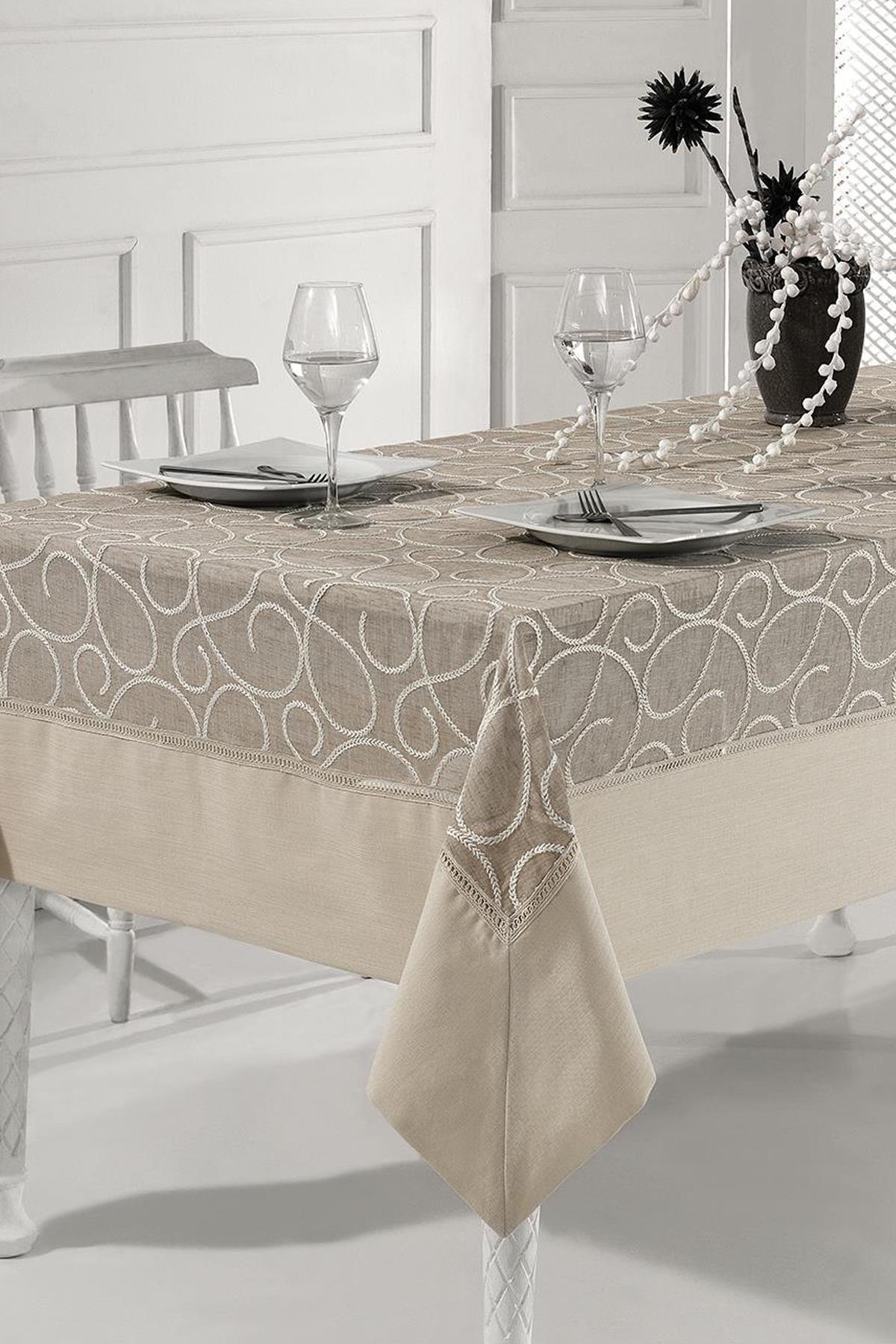 Beige patterned tablecloth with an elegant two-person table setting on a modern dining table