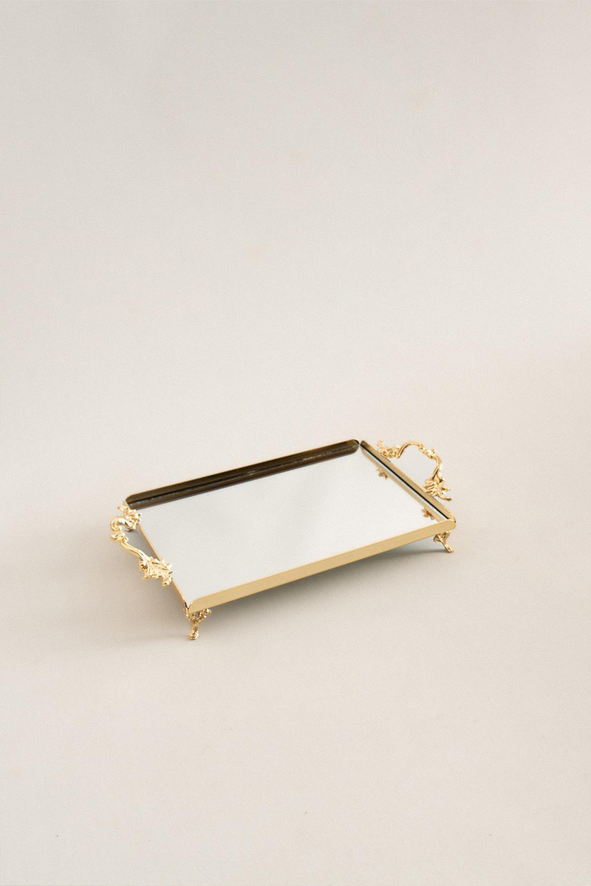 Small rectangular tray with elegant gold handles and feet, featuring a mirrored surface, decorative serving tray