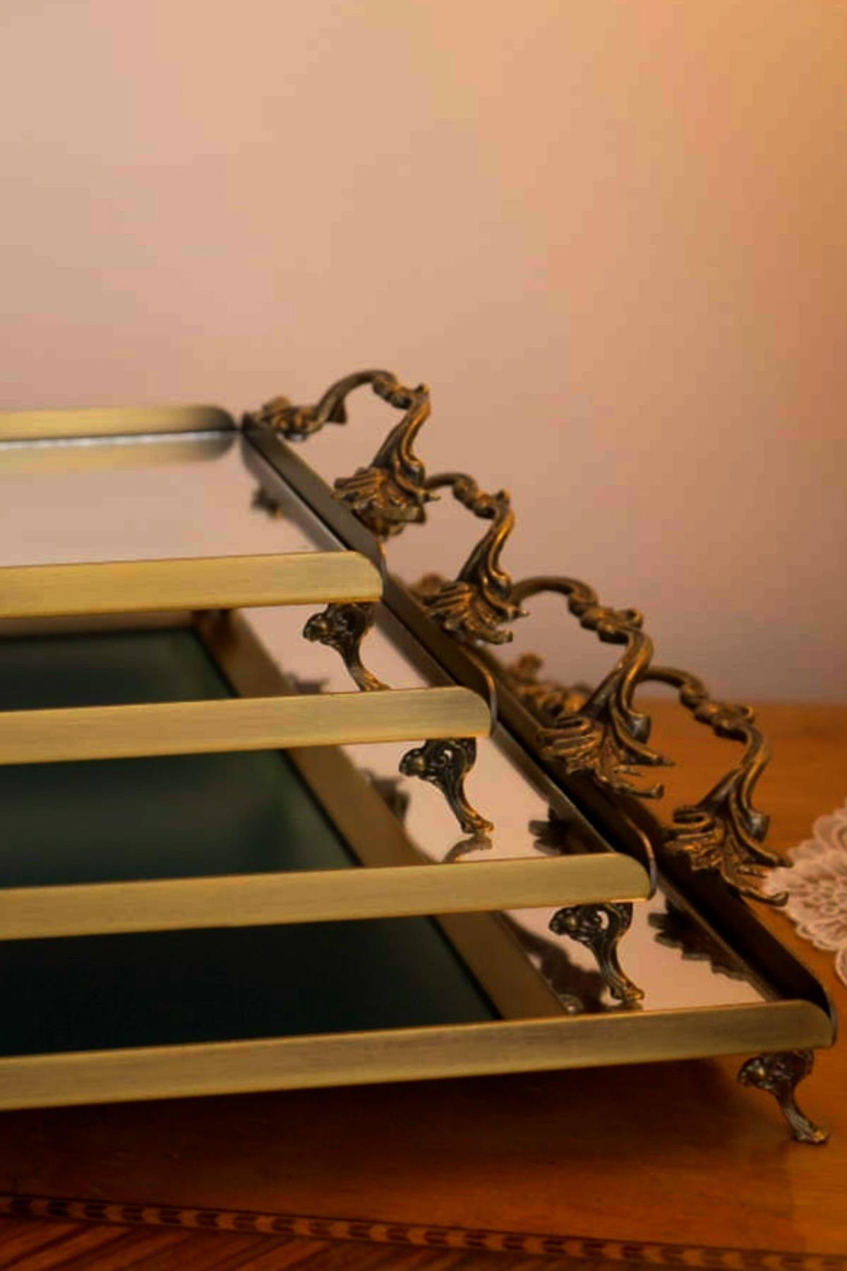 Large metal tray with elegant handles and a distressed finish, featuring a reflective surface for decorative table presentation.