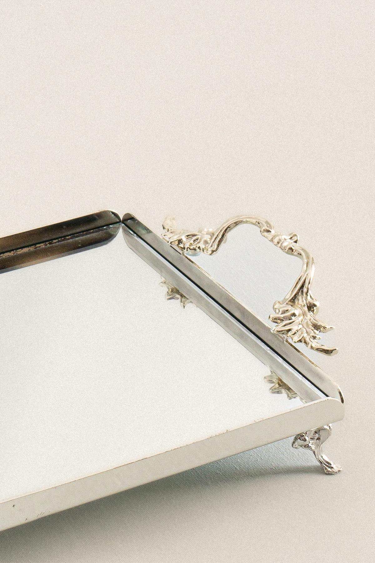 Small rectangular silver serving tray with elegant handles and decorative feet
