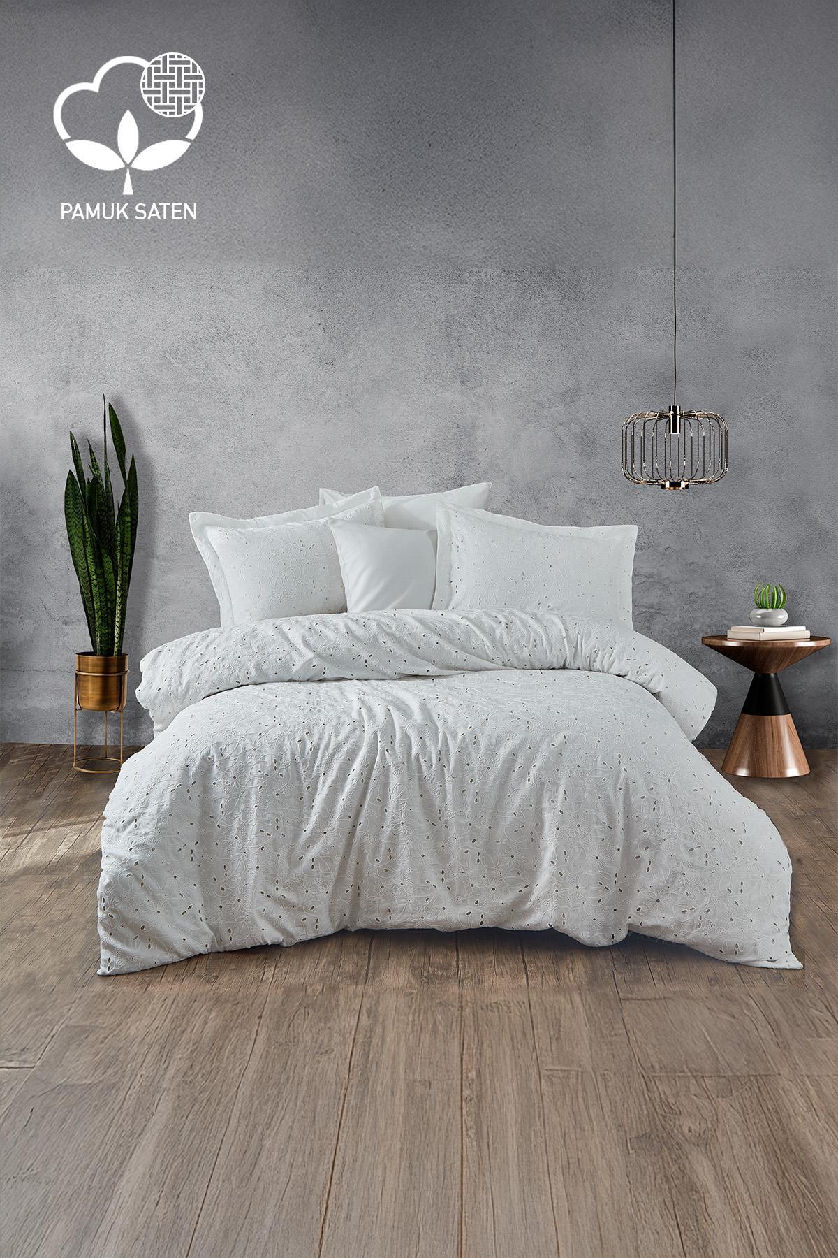 Nill embroidered cotton sateen double duvet cover set in white, in a modern bedroom