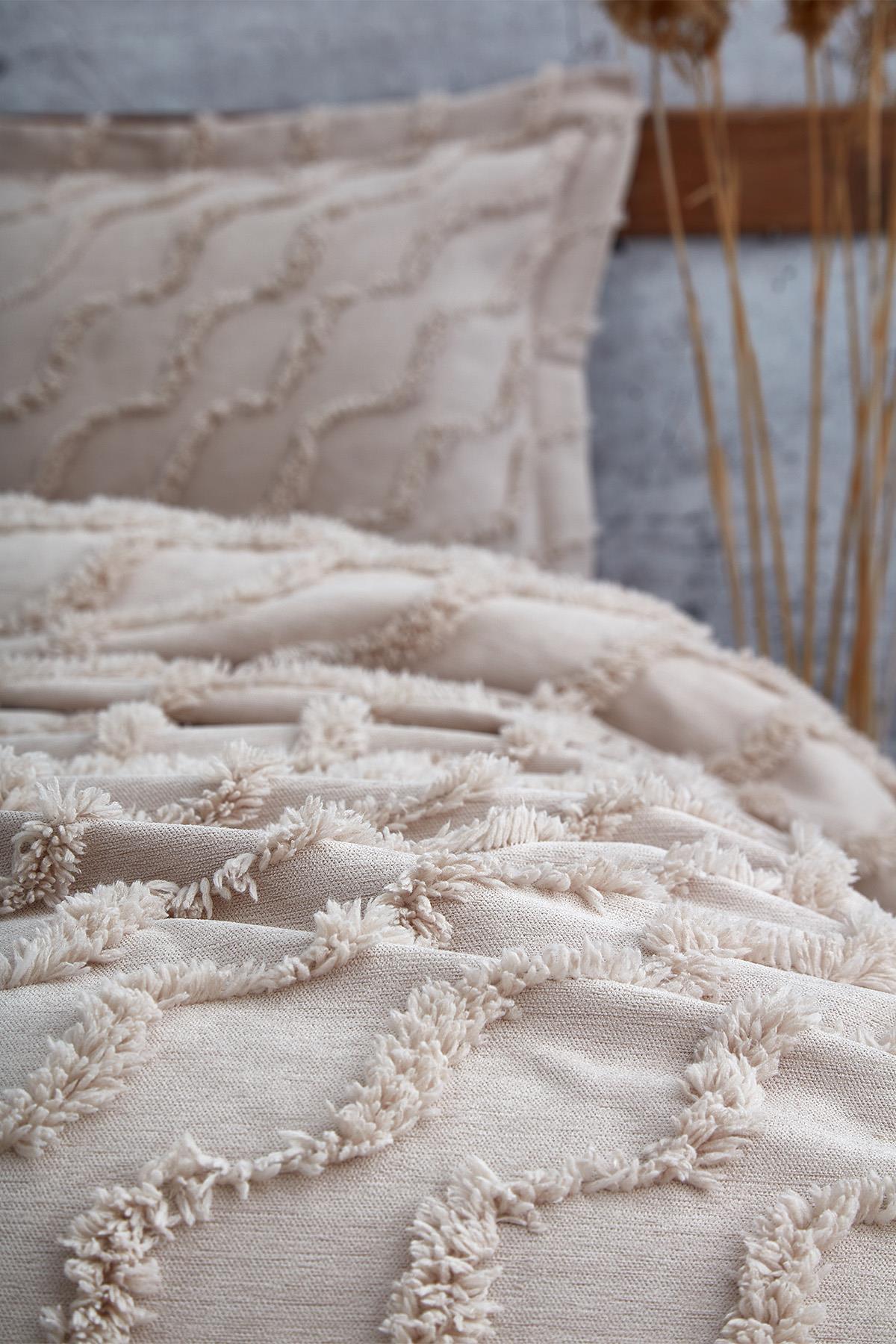 Linen-textured, tassel-detailed beige single bedspread and pillow